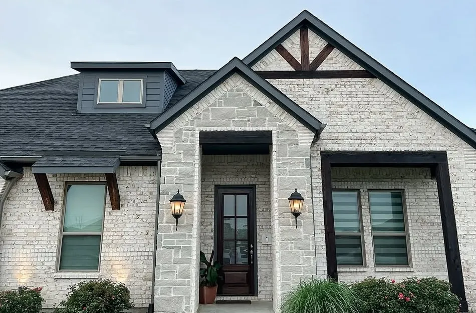 After: the same home with freshly stained dark beams and front door